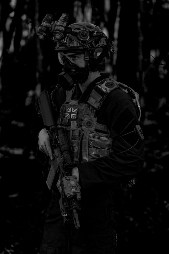 Nautilus International Soldier Wearing Tactical Engagement System and Personal Protective Equipment carrying C8 rifle
